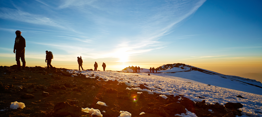 Climbers on the crater rim at sunrise